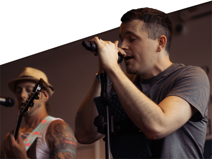 The Smoove Series performing live – Mike and Joe on stage delivering high-energy vocals.